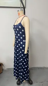 Navy blue slim fit maxi dress with white polka dots displayed on a mannequin.