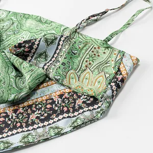 Close-up view of a green paisley print camisole featuring delicate bow and thin straps