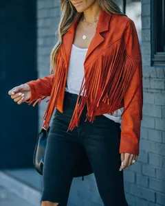 Detailed macro view of long tassels on a stylish orange faux suede jacket for women