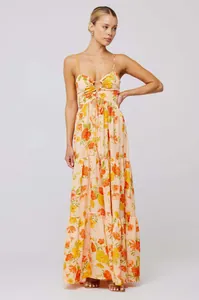Model wearing a peach bohemian floral spaghetti strap maxi dress with tiered skirt detail