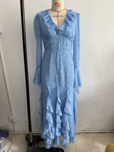 Full view of light blue floral maxi dress with ruffled collar and bell sleeves