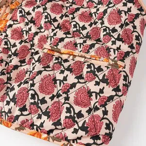 Close-up view of the quilted floral print fabric and pocket detail on a stylish vest
