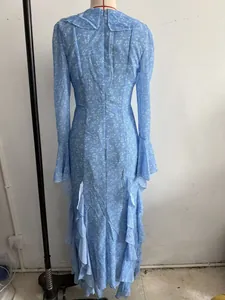 Detailed back view of a light blue floral long dress with ruffled layers and bell sleeves