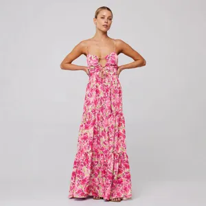 Floral tiered maxi dress with spaghetti straps and bust tie detail for bohemian beach style.