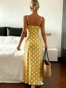 Elegant back view of a chic yellow and white polka dot sleeveless maxi dress for women
