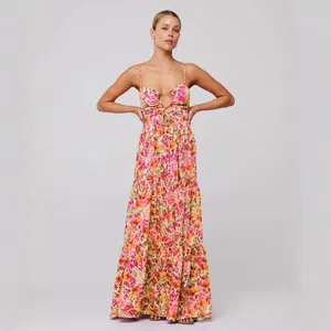 Bohemian floral spaghetti strap maxi dress with cutout tie-front detail and tiered skirt.