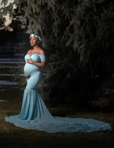 Full detail view of light blue maternity photography dress with long chiffon train