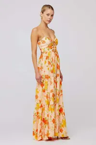 Side view of bohemian floral print maxi dress with camisole straps and waist cut-outs