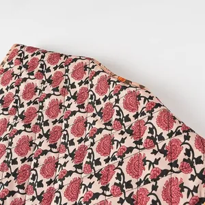 Close-up of pink floral quilted fabric detail for women's fashion vest.
