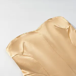 Close-up of champagne gold satin fabric texture for elegant mermaid skirt suit set.