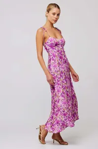 Full-length view of a purple floral spaghetti strap dress on a professional model
