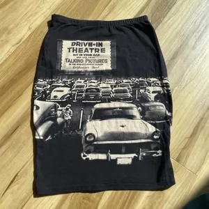 Detailed macro view of the vintage drive-in theatre print on a black midi pencil skirt