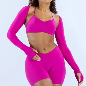 Vibrant hot pink seamless yoga set with sports bra, shorts, and long sleeve shrug bolero