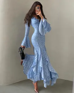 Detailed full view of an elegant blue floral maxi dress with bell sleeves and ruffles
