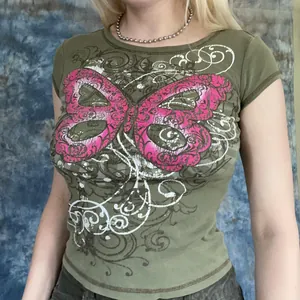 Close-up of green short sleeve t-shirt featuring a vibrant pink butterfly graphic print