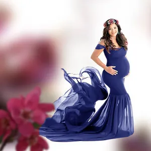 Detailed view of navy blue maternity gown with a flowing chiffon train