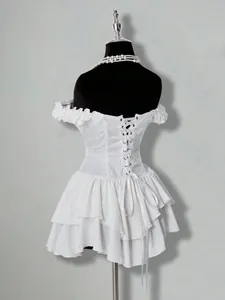 Detailed view of the corset-style back of a white ruffled mini chiffon dress