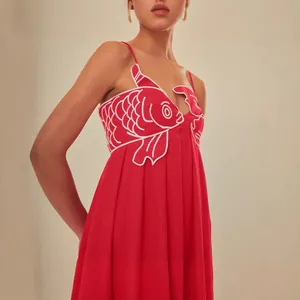 Red camisole maxi dress featuring detailed white goldfish embroidery and high waist