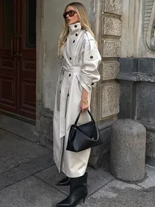 Elegant beige double-breasted long trench coat with high collar and belted waist detail