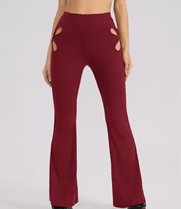 Elegant burgundy ribbed high-waist flare pants featuring stylish hip cut-out details