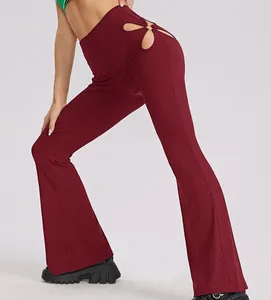 Close-up detail view of burgundy ribbed high waist flare pants with hip cutout design