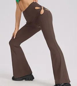 Close-up of brown ribbed high waist flare pants with fashionable hip cutout detail.