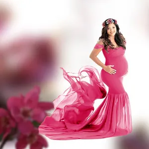 Elegant bright pink maternity photography dress featuring a long flowing chiffon tail
