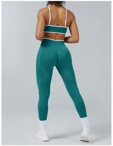 Full back view detail of a teal fitness set highlighting high-waisted legging fit