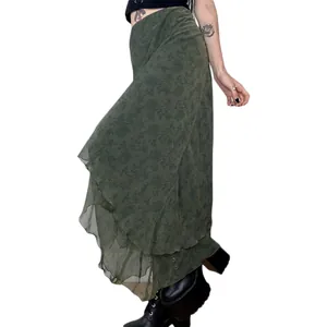 Detailed view of an irregular green floral chiffon skirt with an elegant layered hem