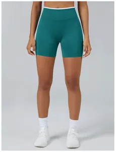 Detailed front view of high-waisted seamless teal yoga shorts with white waistband trim