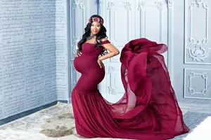 Elegant burgundy maternity dress with a long flowing chiffon train for photography