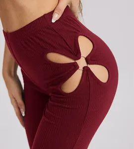 Close-up view of wine red ribbed pants featuring unique flower cutout and silver ring detail