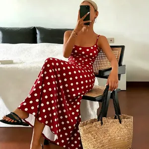 Elegant red sleeveless maxi dress with white polka dot print, perfect for summer vacation.