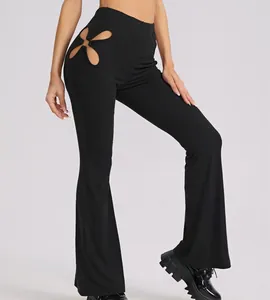 Detailed macro view of black ribbed high-waisted flare pants with unique flower hip cutout