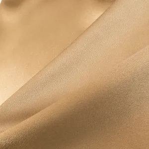 Macro detail view of premium champagne gold fabric texture for solid color suit sets