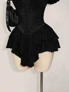 Close-up of black jacquard corset mini dress with layered ruffle chiffon skirt