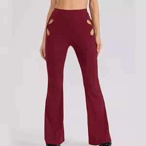 High-waisted burgundy flared pants with ribbed texture and stylish hip cut-out details