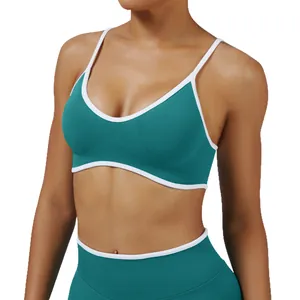 Teal ribbed sports bra and leggings set with white trim for yoga and fitness training.