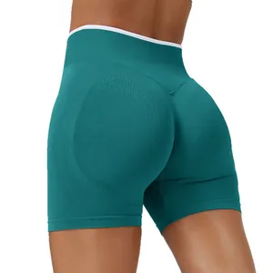 High-waisted teal seamless yoga shorts with peach lift design for fitness.