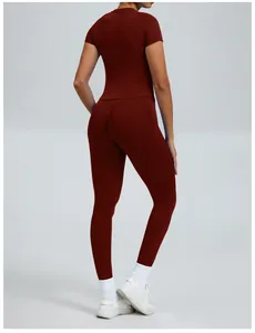 Back view detail of a slim fit burgundy yoga set with short sleeves and leggings.