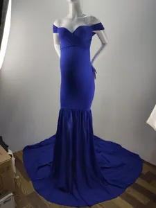 Royal blue maternity photography gown with off-the-shoulder neckline and long chiffon tail