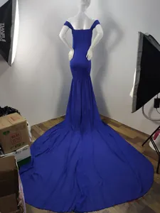 Back view of a royal blue maternity gown with a long chiffon train for photography