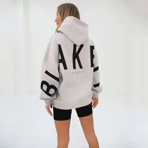 Back view of trendy oversized gray hoodie for women featuring bold BLAKE black text print