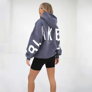 Detailed view of grey oversized hoodie with white BLAKE print and original life text.