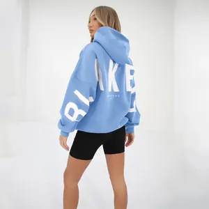 Back view of light blue oversized hoodie featuring bold white 'BLAKE' lettering print