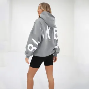 Detailed back view of oversized grey hoodie with bold white BLAKE letter print