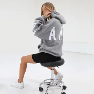 Back view of a trendy grey oversized hoodie with a bold white graphic letter print