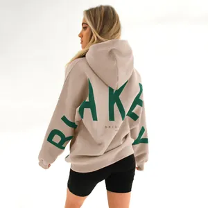 Back view of an oversized oatmeal hoodie featuring a prominent green Blake logo print