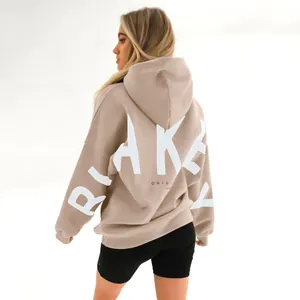 Detailed back view of a beige oversized hoodie with a white BLAKEY print.