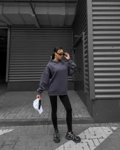 Fashionable oversized charcoal grey hoodie for women in an urban street style setting